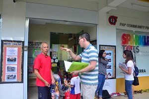 Volunteers engaging parents and children with survey questions
