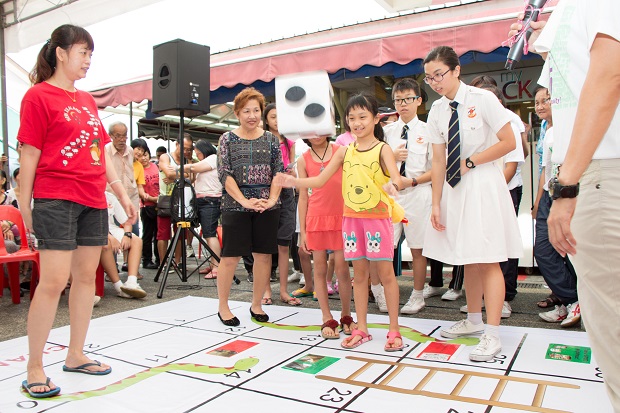 Playing of a life-sized “Good Neighbours” Snakes & Ladders game with residents
