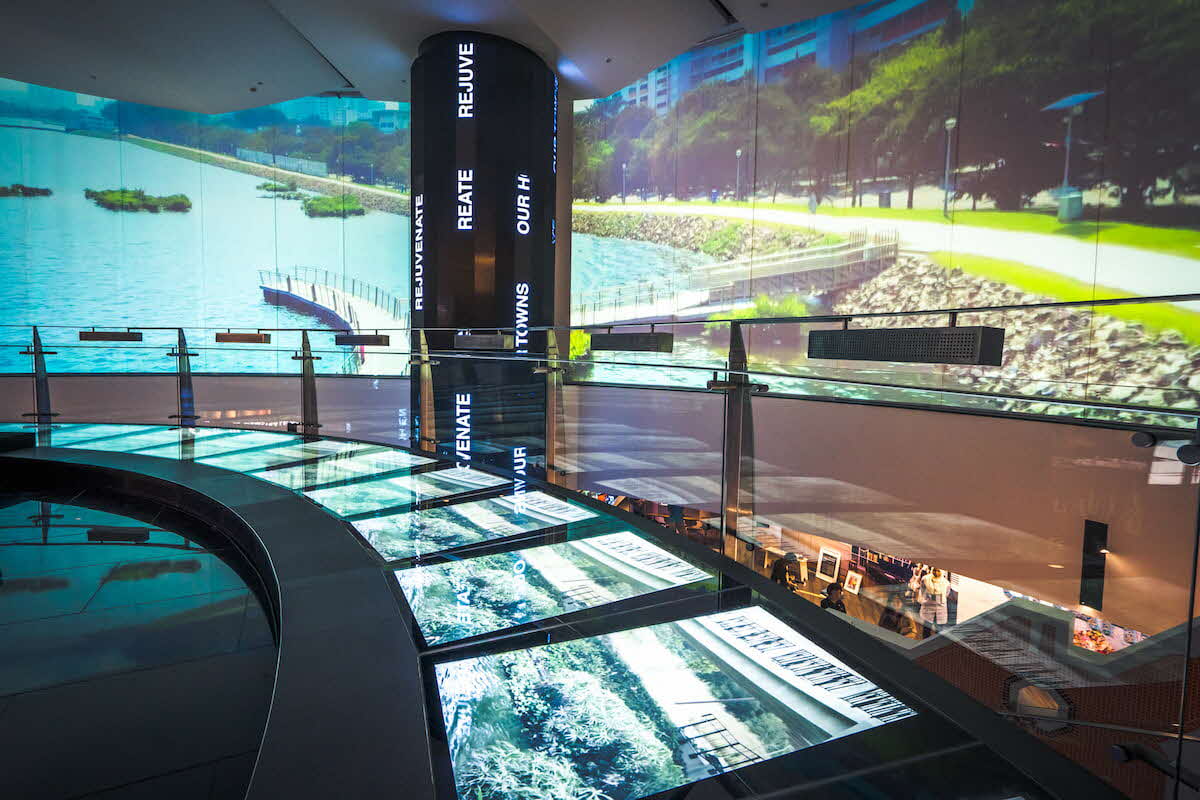 Area outside HDB LIVINGSPACE Gallery showing videos of HDB towns