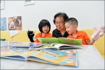 Reading activities between seniors and children